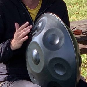 a man holding a handpan